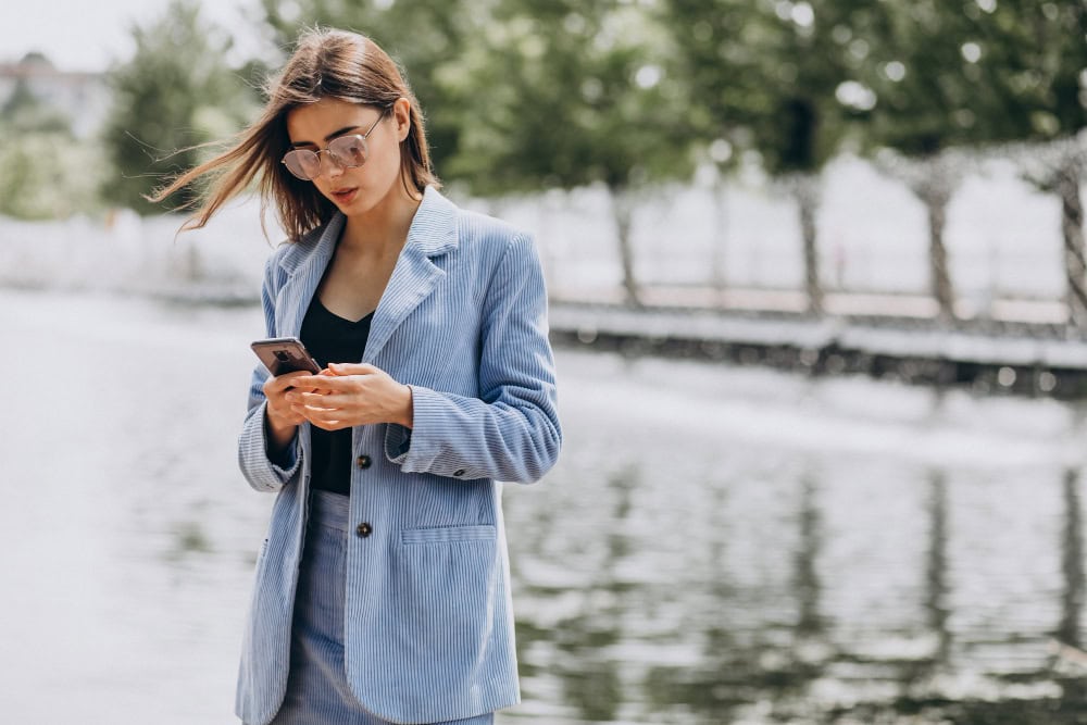Woman accessing online therapy from her mobile phone.